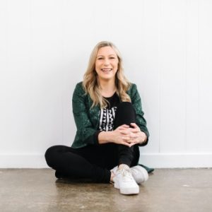 Alison Crabb the Connected Leader sitting on the floor smiling and relaxed.